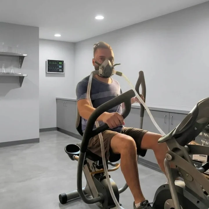 A person using the EWOT system during stationary cycling